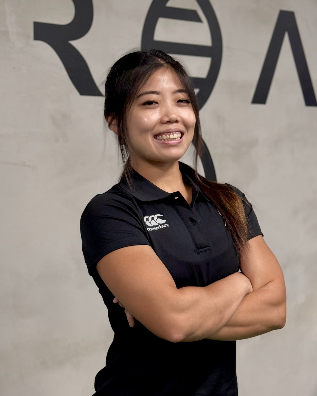 Female trainer in Unreal Personal Training uniform posing for the camera